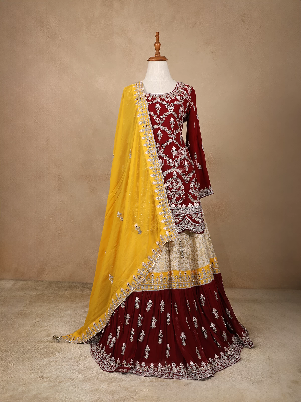 Dark Red With Yellow Net Lehenga Embellished With Floral Embroidery Paired With Dupatta