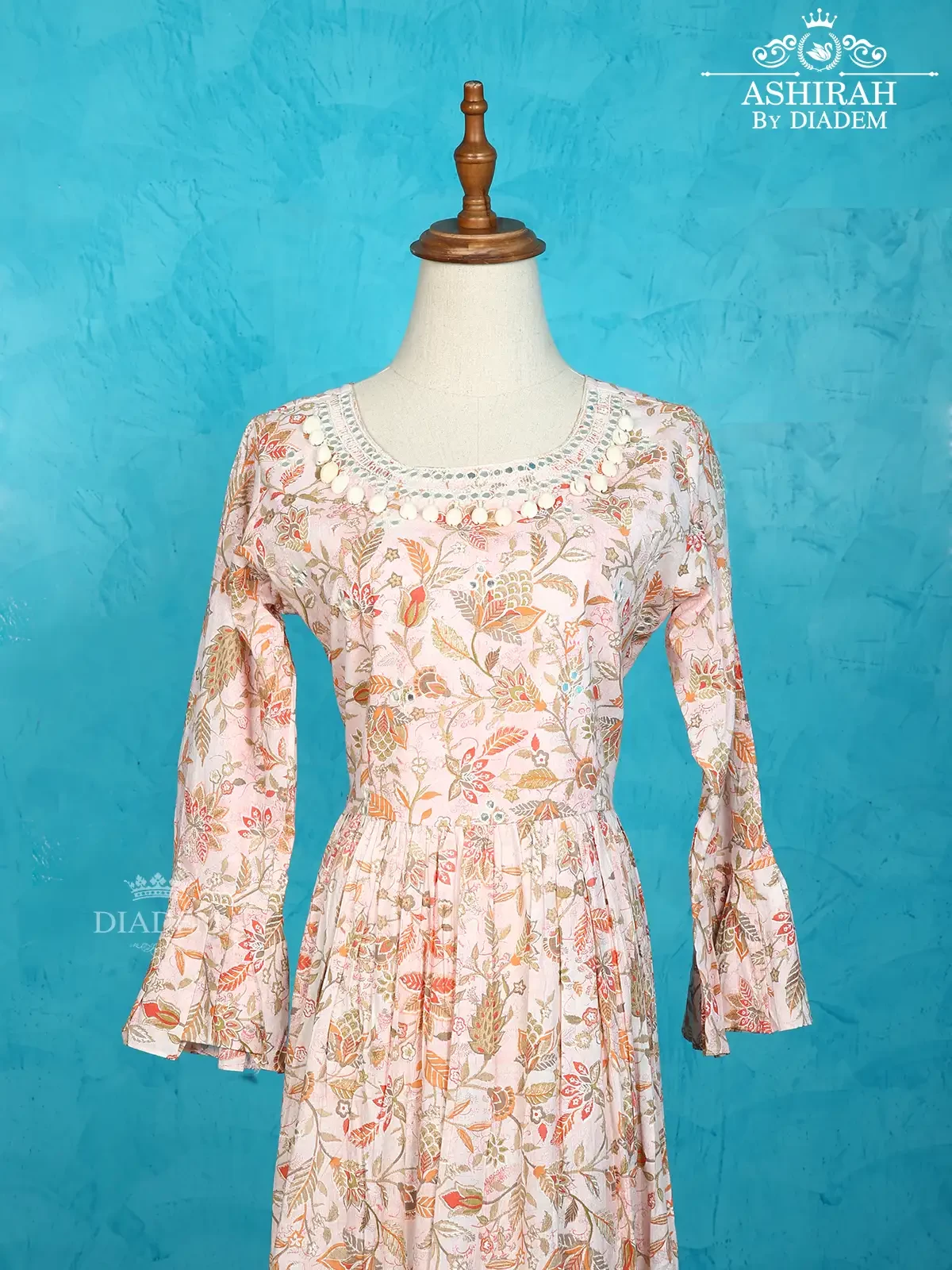 Light Peach Cotton Kurti Adorned With Floral Prints And Thread Work