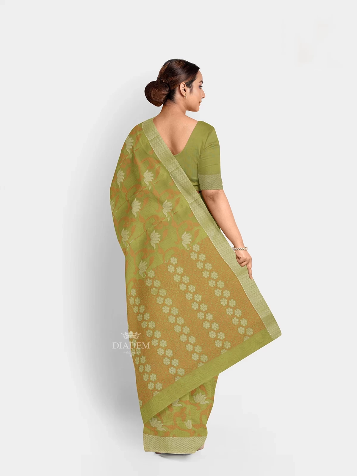 Pista Green Silk Cotton Saree With Zari Butta On The Body And Silver Zari Border.
