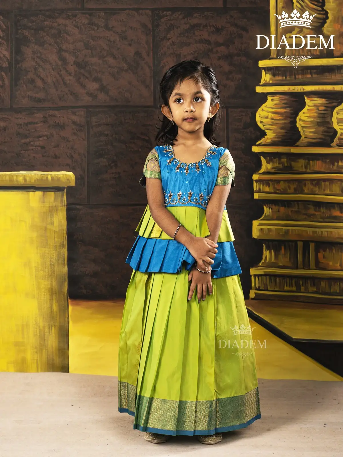 Parrot Green With Blue Pattu Pavadai And Top Enhanced In Embroideries