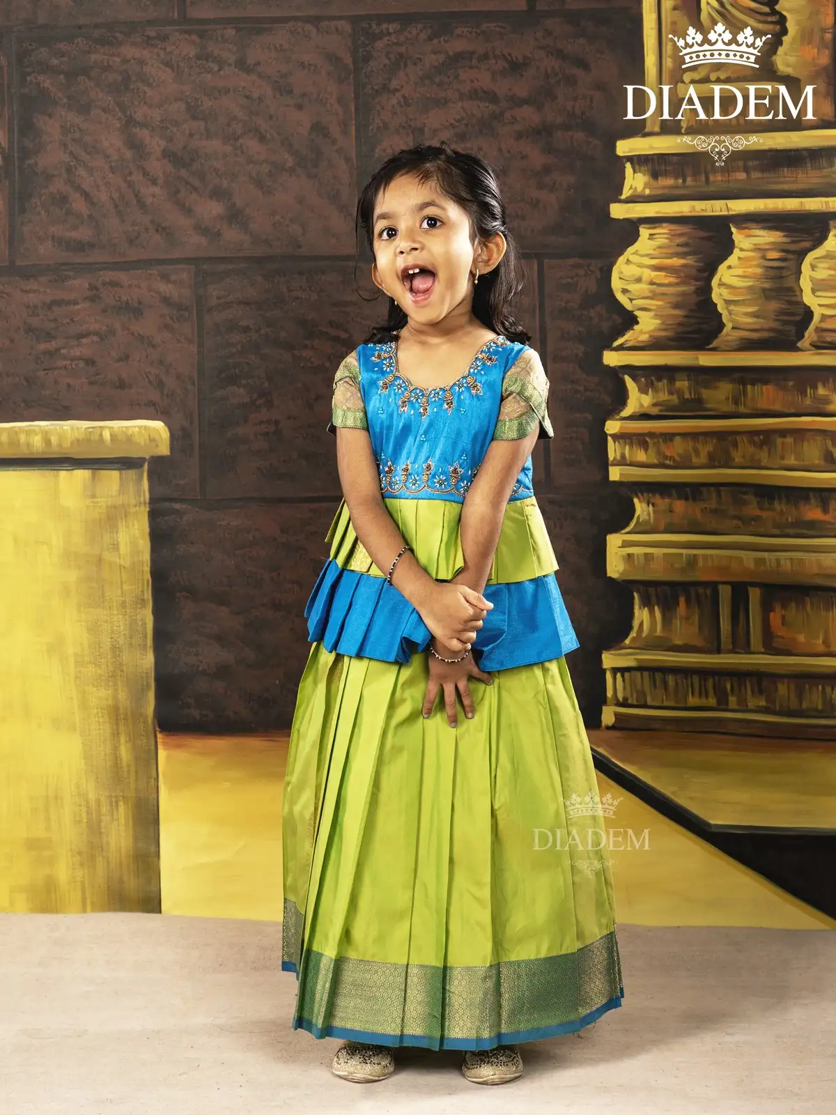 Parrot Green With Blue Pattu Pavadai And Top Enhanced In Embroideries
